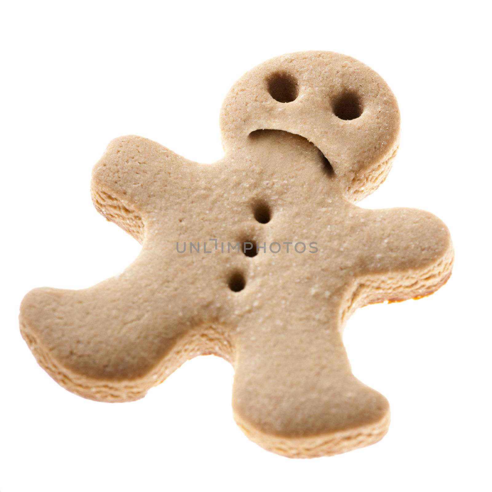 Homemade Gingerbread man cookie with a sad expression isolated on white background