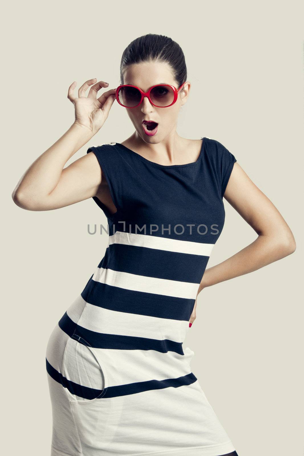 Portrait of a beautiful fashion woman posing with sunglasses
