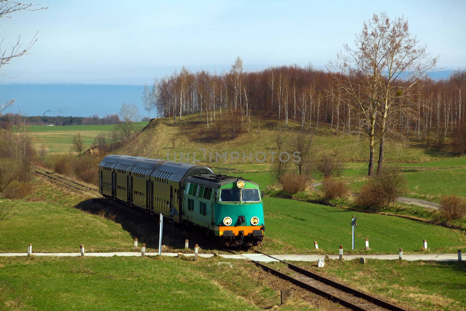 Passenger train passing through countryside by remik44992