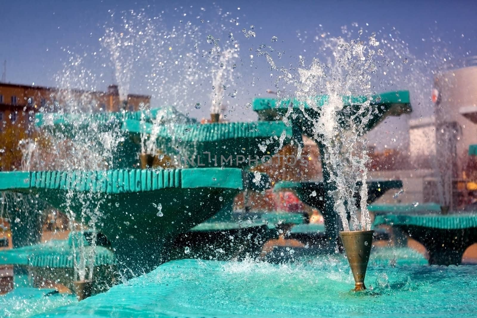 Splashes of fountain water in a sunny day 
