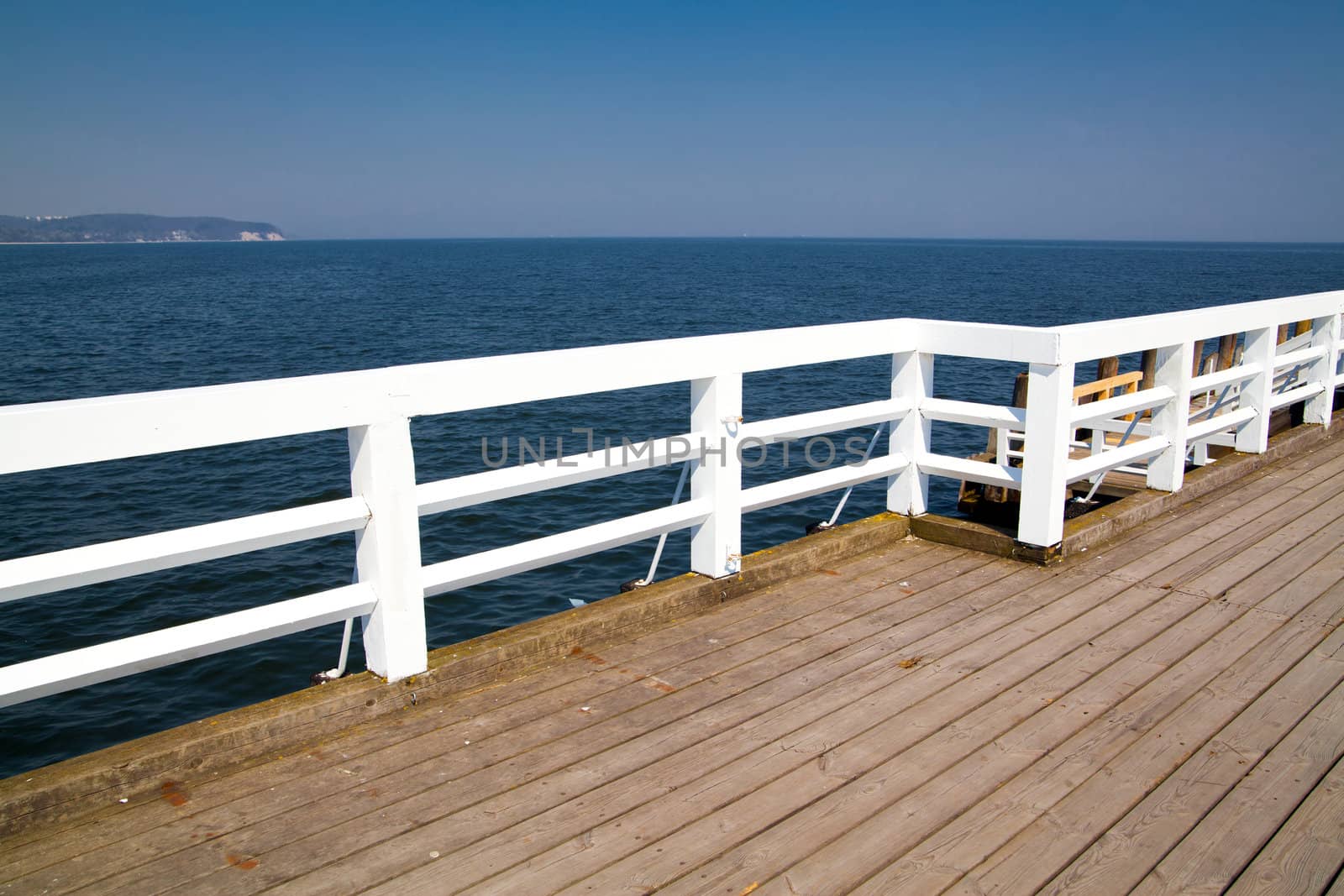 A wooden pier white barriers

