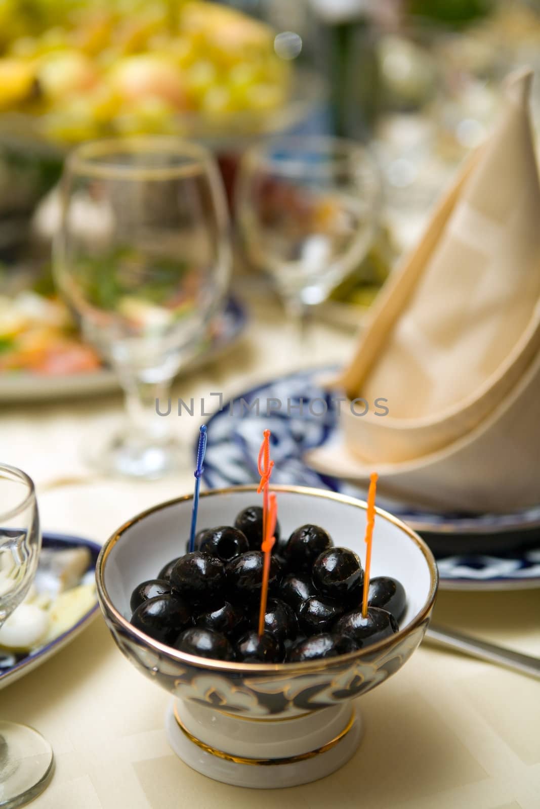 Plate with black olives on restaurant table