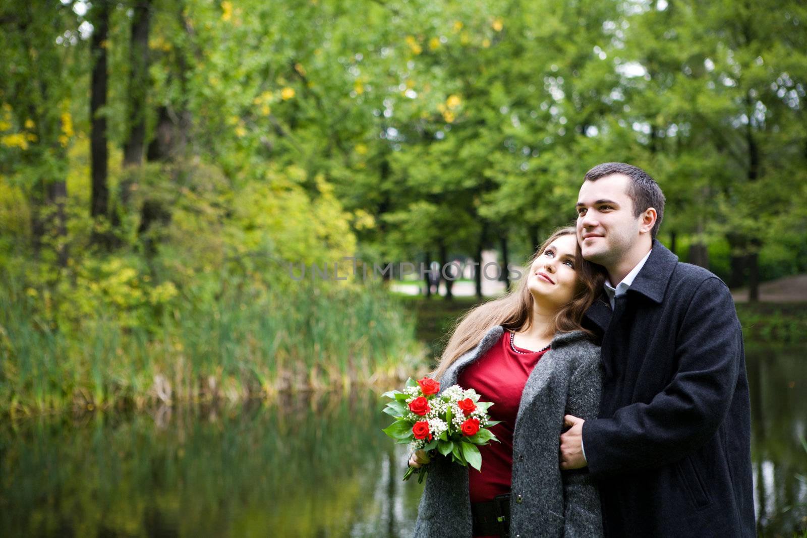 Two young lovers enjoying each other in park