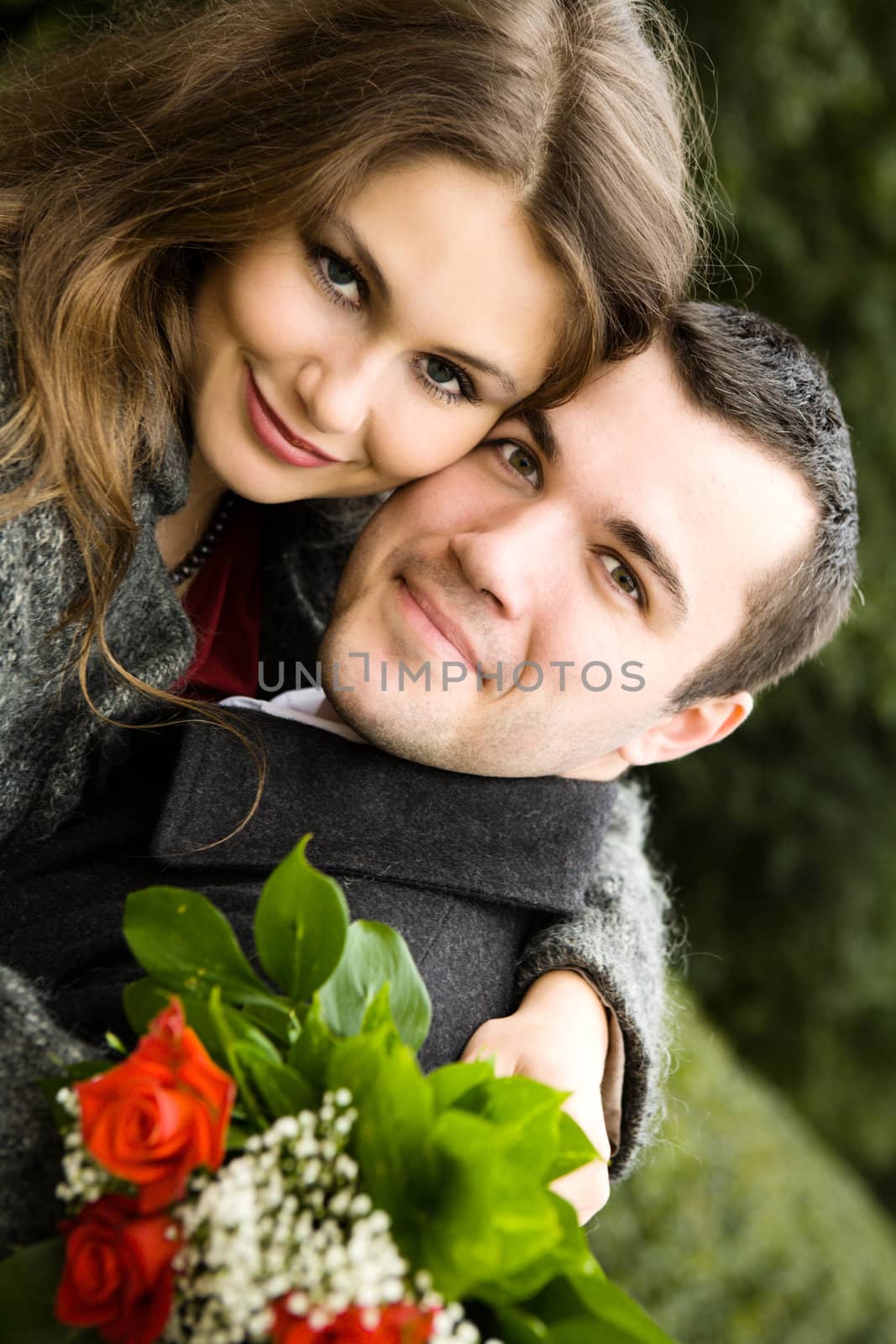 Two young lovers enjoying each other in park