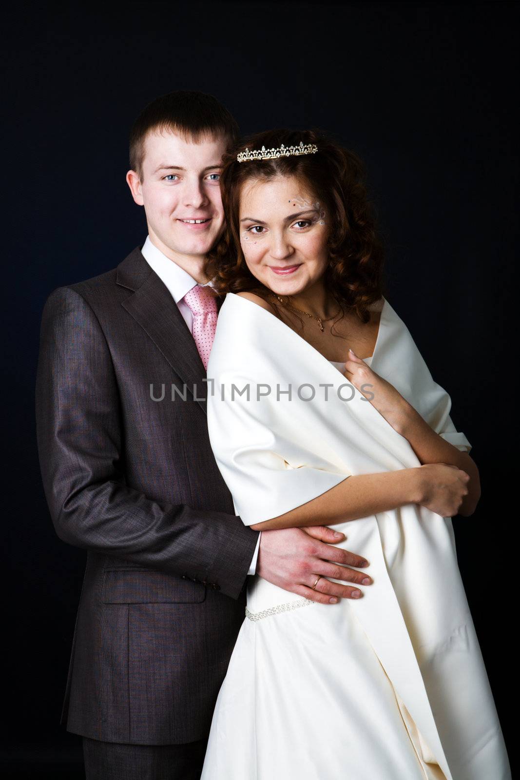 Portrait of Happy New Married couple over dark background