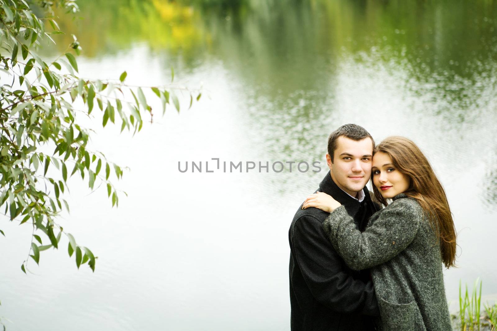 Two young lovers enjoying each other in park