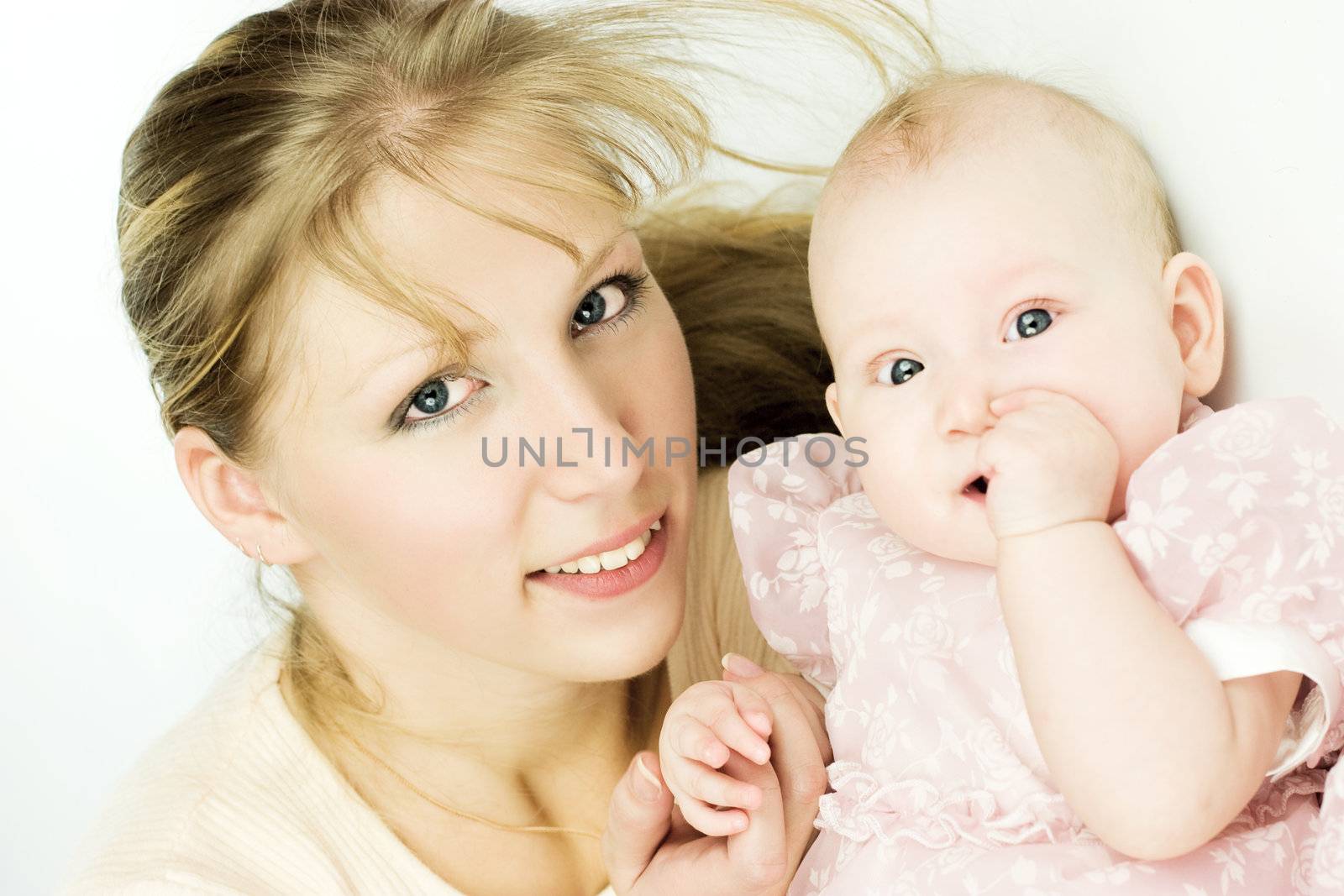 Mother with six month baby looking at you