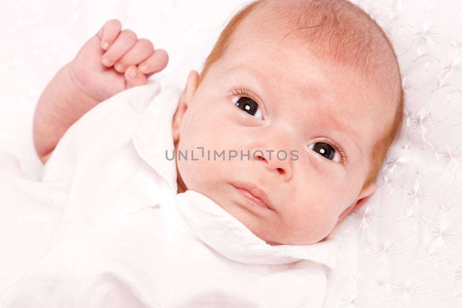 Baby girl in the age of one months isolated on white