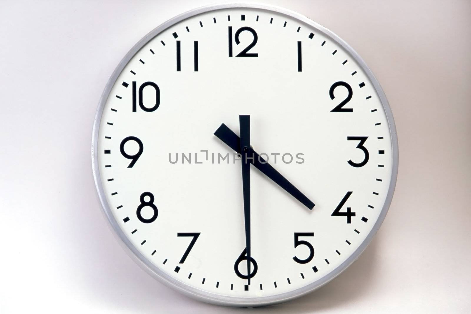 A big and white clock on the wall
