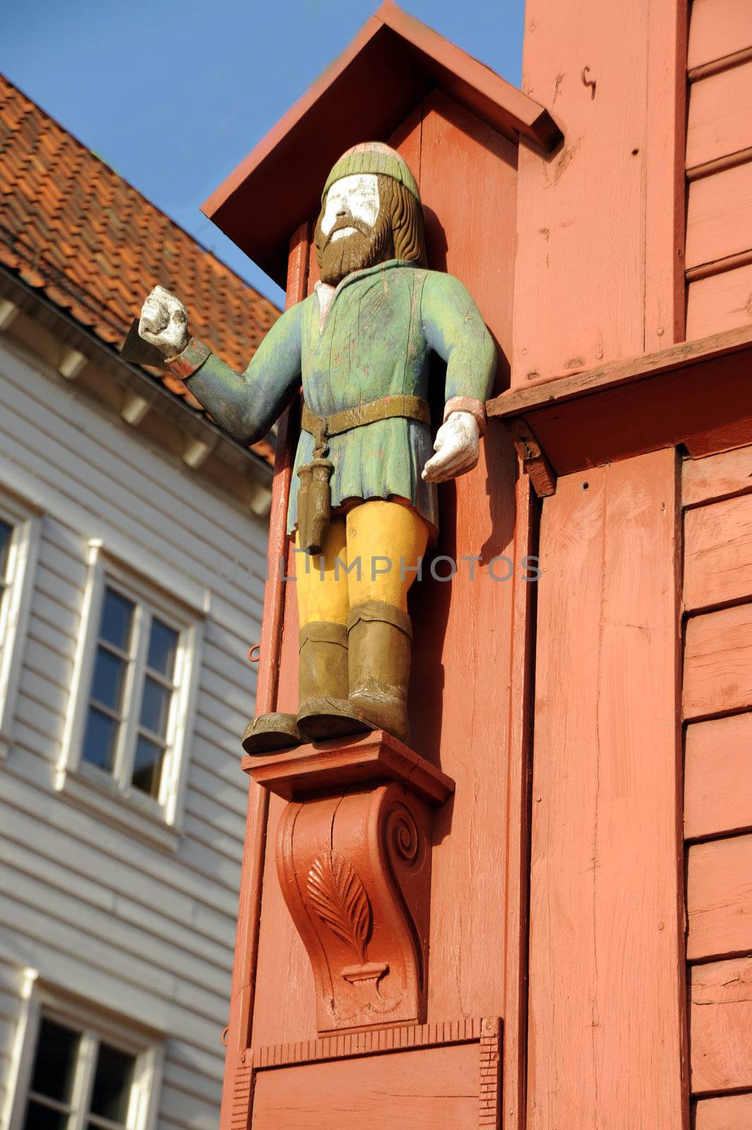 Figure on a facade of the ancient wooden house in Bergen, Norway