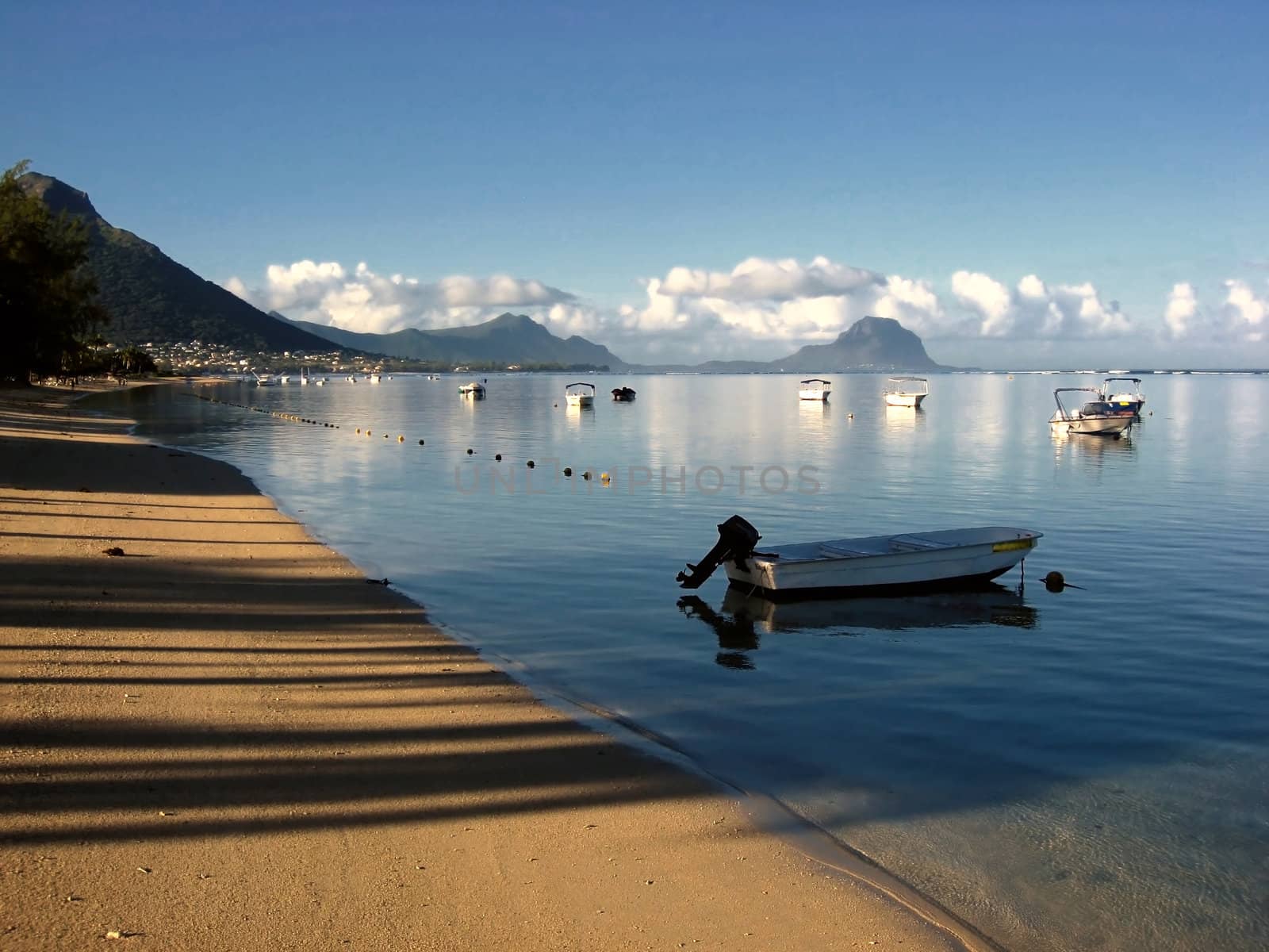 Mauritius beach with small boats and blue sky