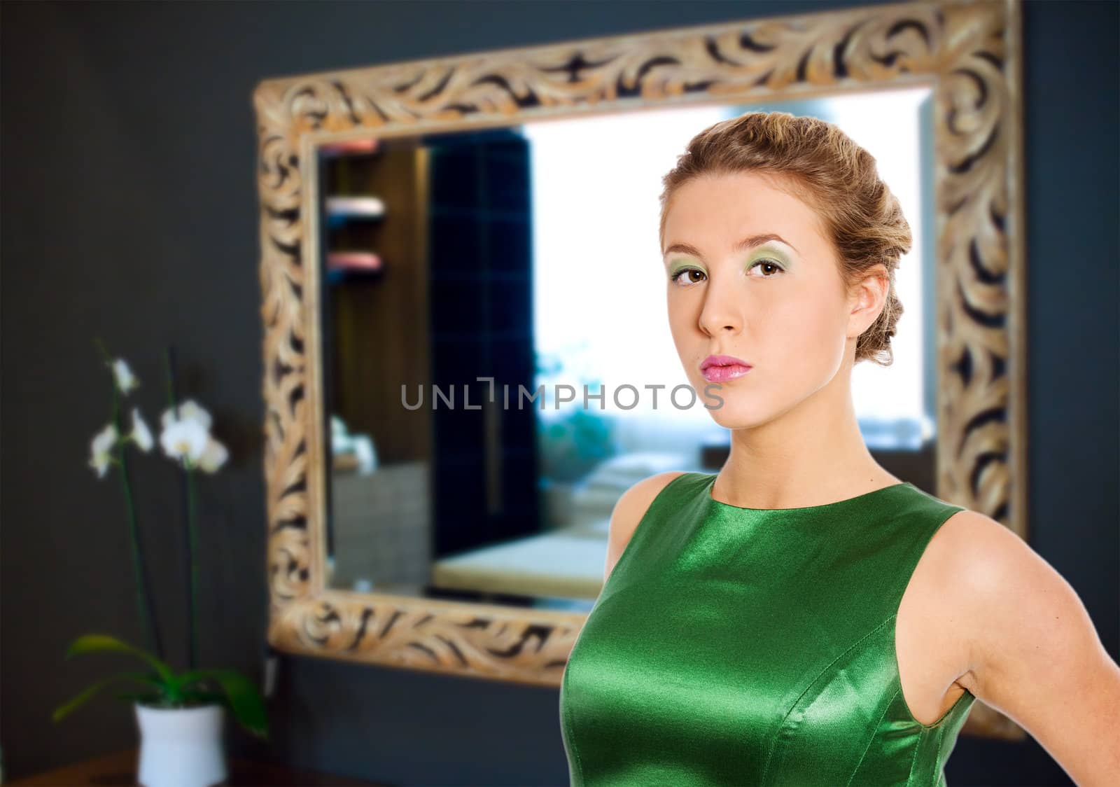 Young woman wearing green dress at home