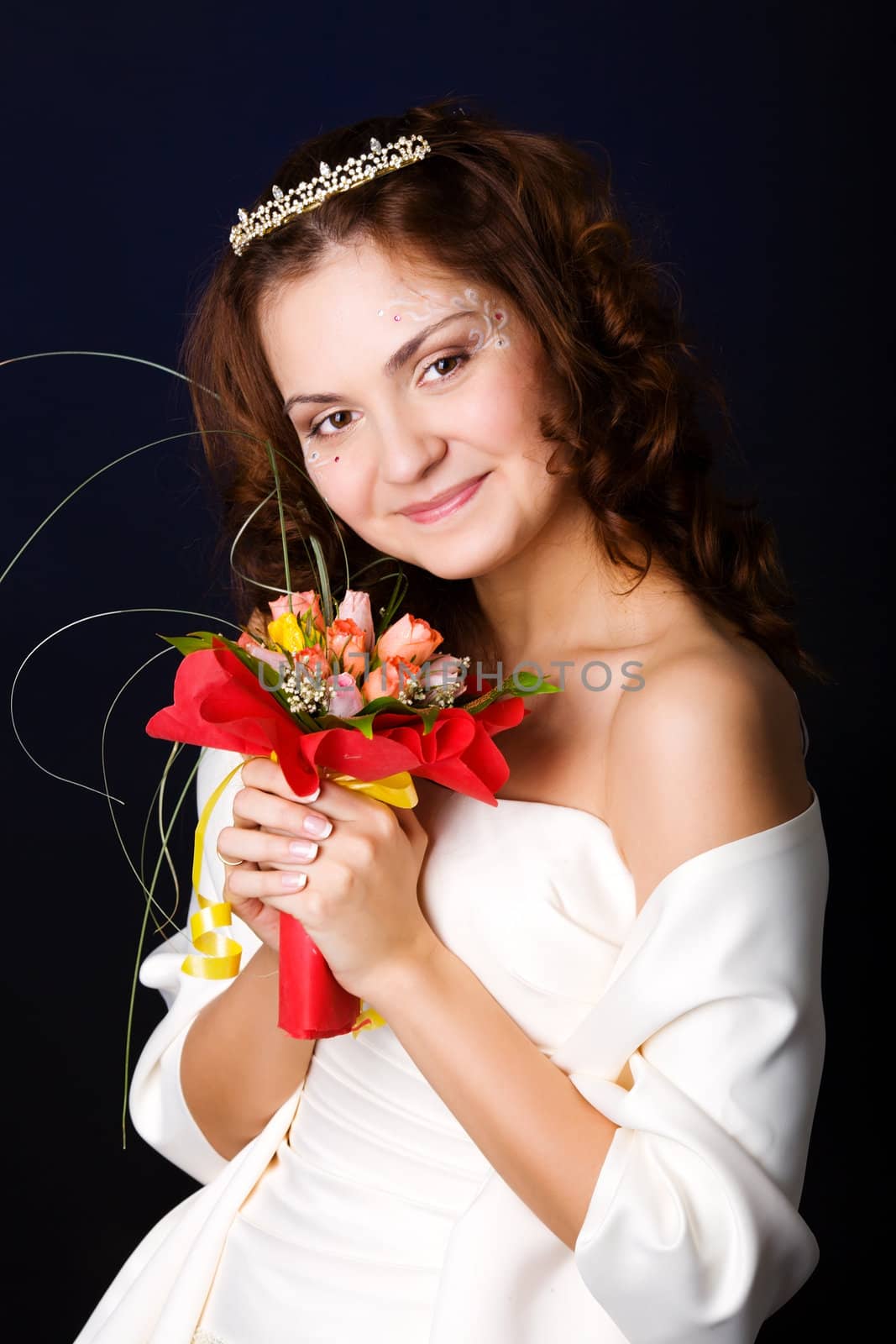 Happy Bride holding bouquet and smiling over dark background