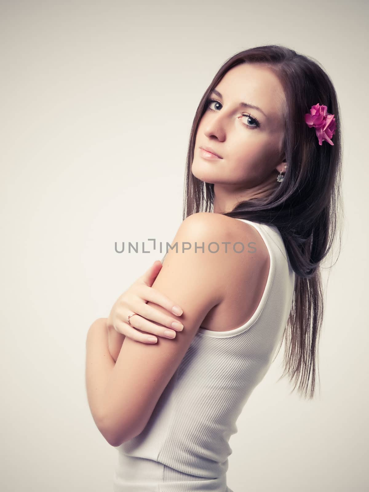 Model in white dress posing in a studio