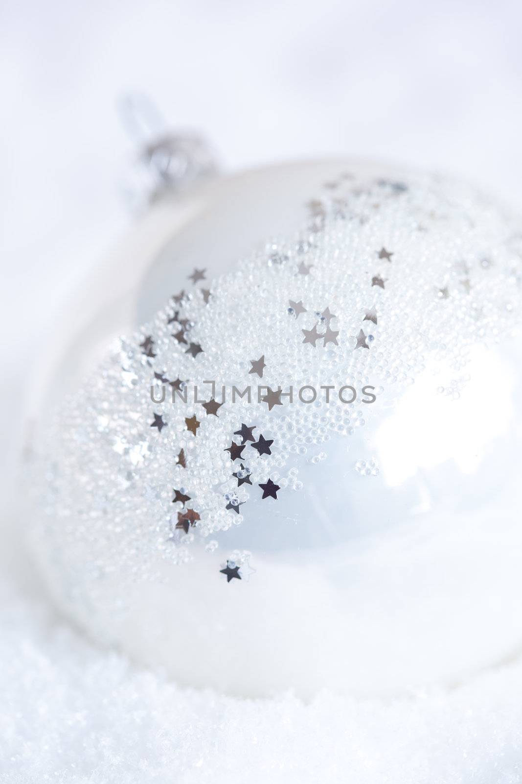 Large christmas bauble with stars and shiny outside in the snow