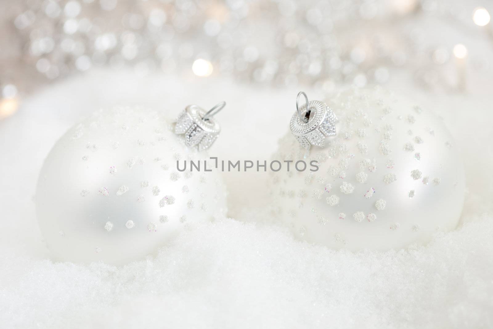 Christmas baubles in snow by Fotosmurf