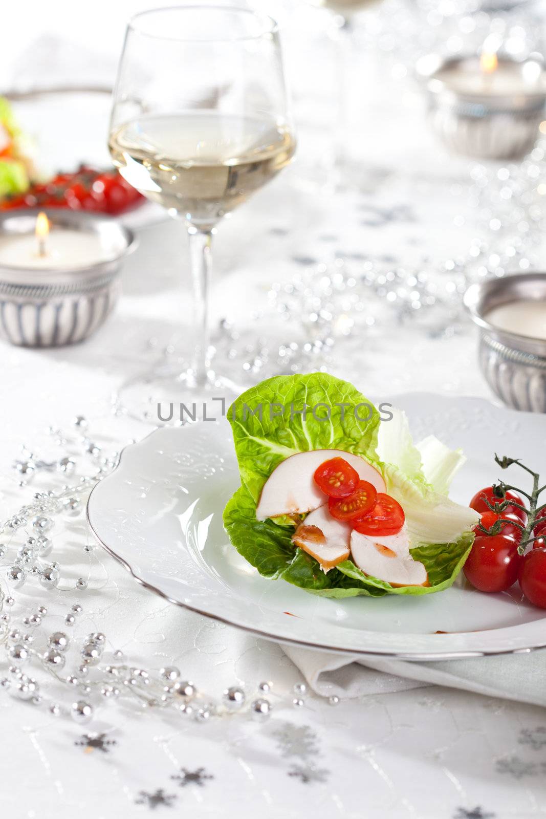 Pretty christmas table setting with small appetizer on plate