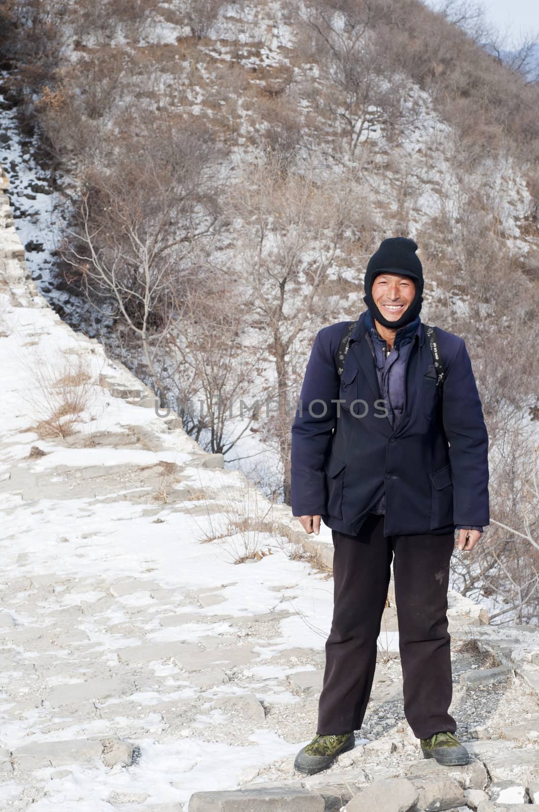Great Wall, China - January 20:  One of the many Chinese men that help carry goods along the Great Wall of China on January 20, 2010.  A very hard way to make income in China.