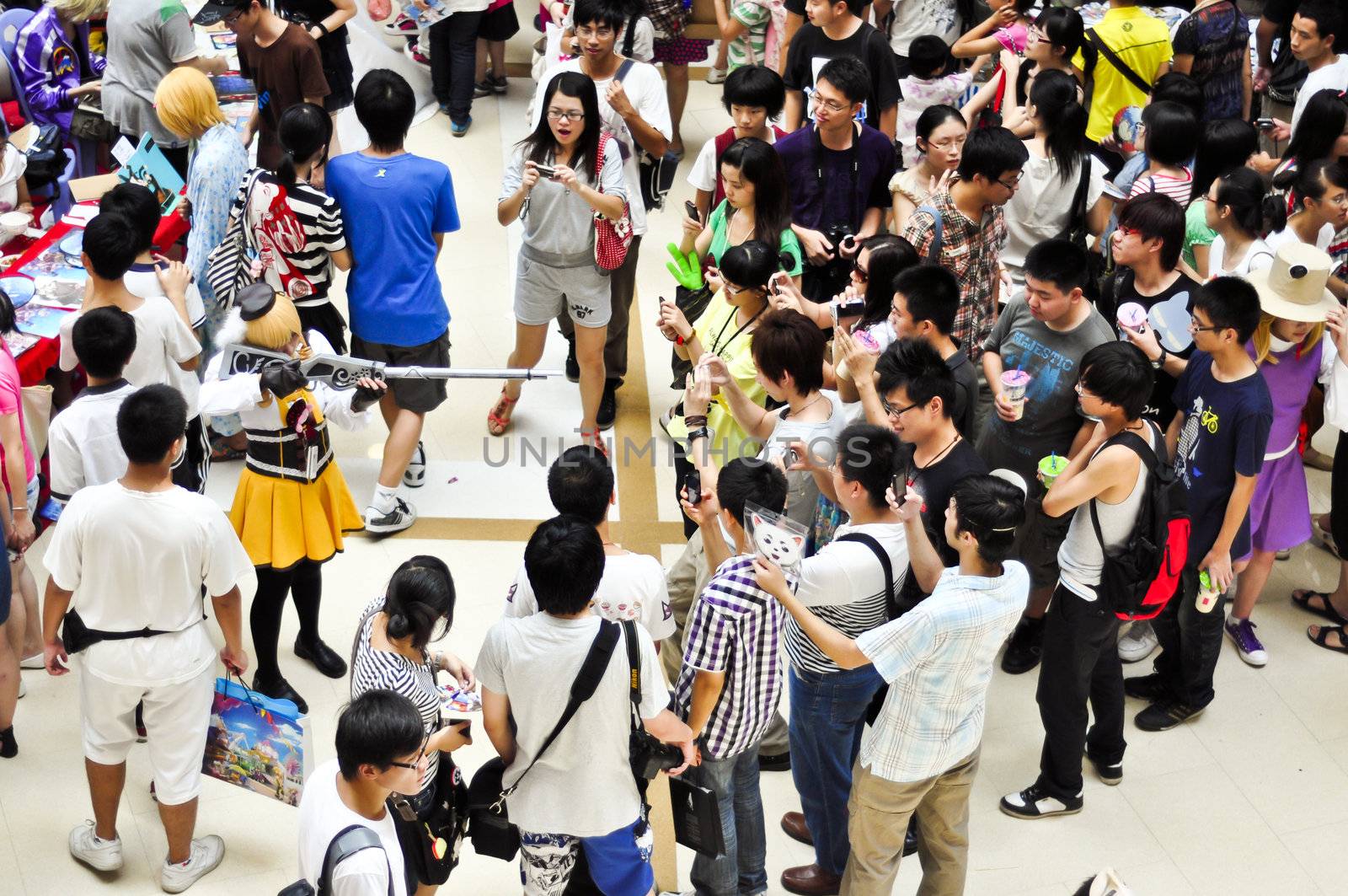 Xiamen, China - July 31:  Young Chinese take pictures of a girl dressed in cosplay at an anual convention in Xiamen, China on July 31, 2011.