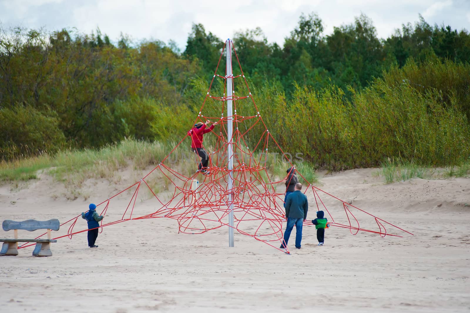 Family relaxing in dune at the Baltic sea in autumn day.