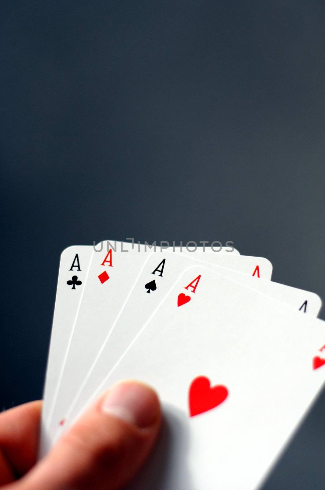hand and four aces showing poker concept with copyspace