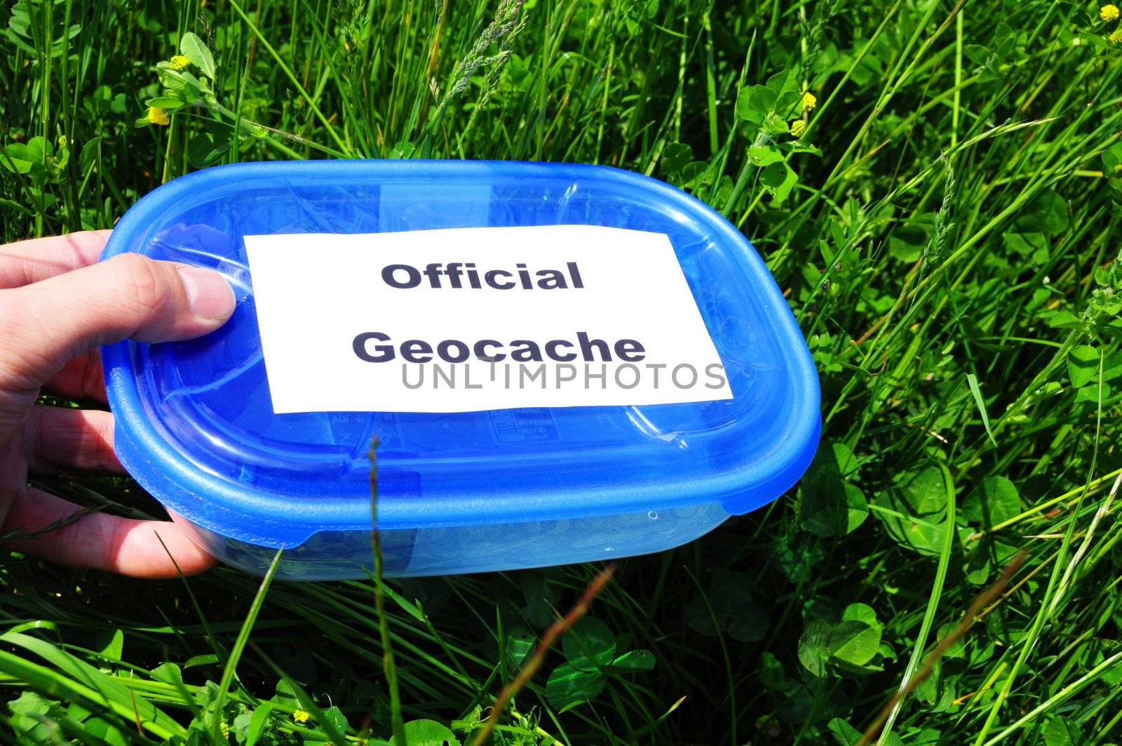 geocaching concept with blue geocache box showing outdoor sports concept