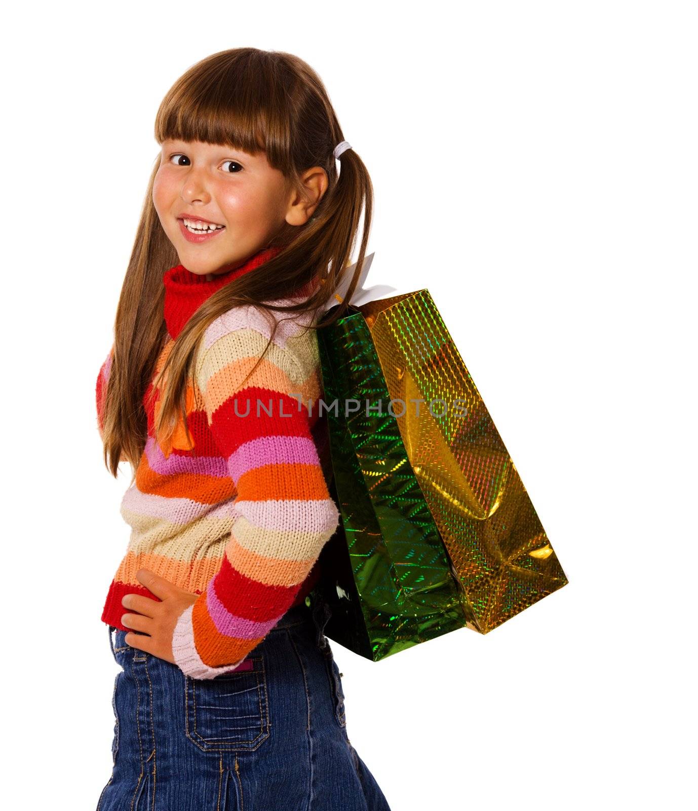 Smiling six years Girl holding presents bags isolated