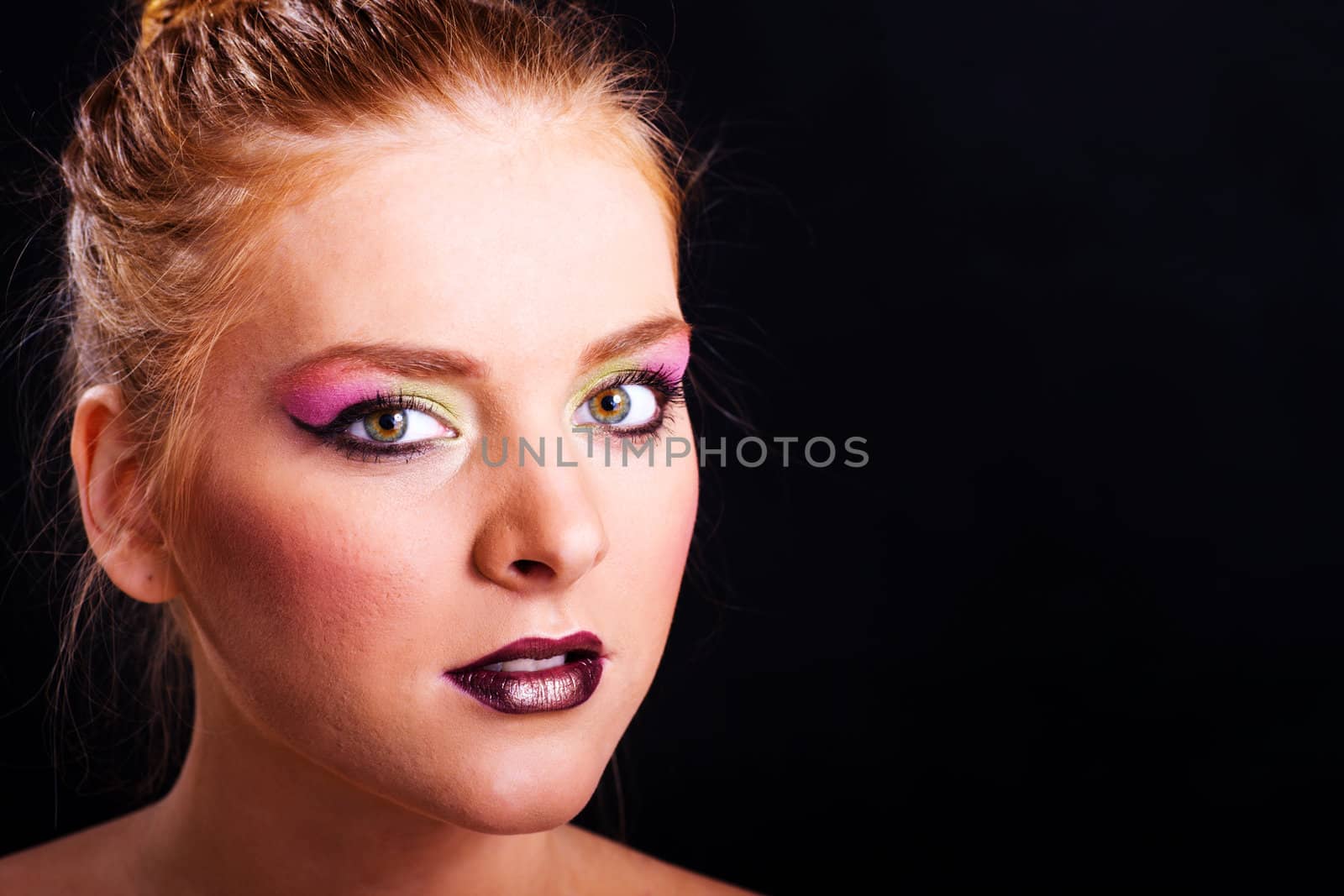 Glamour portrait of young woman over black