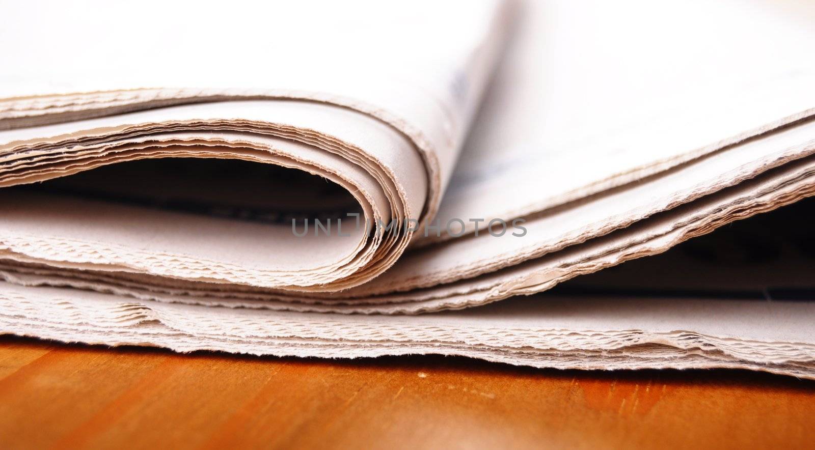 stack of newspaper on desktop showing news concept