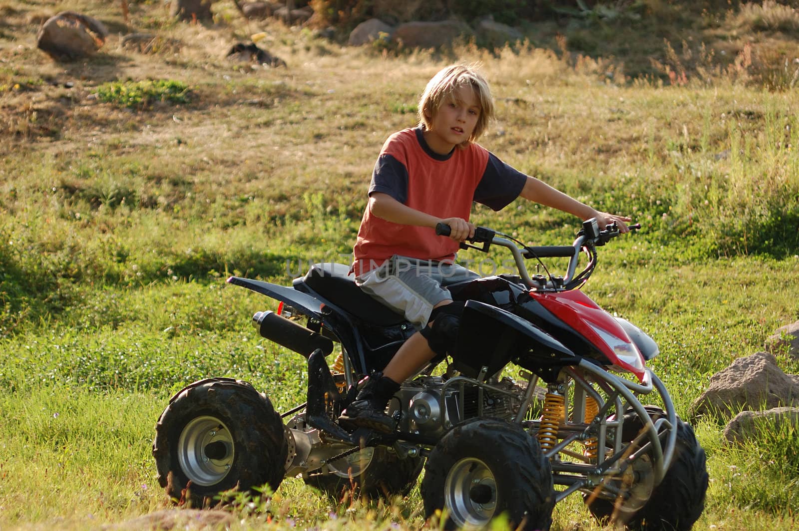 young boy riding ATV for fun