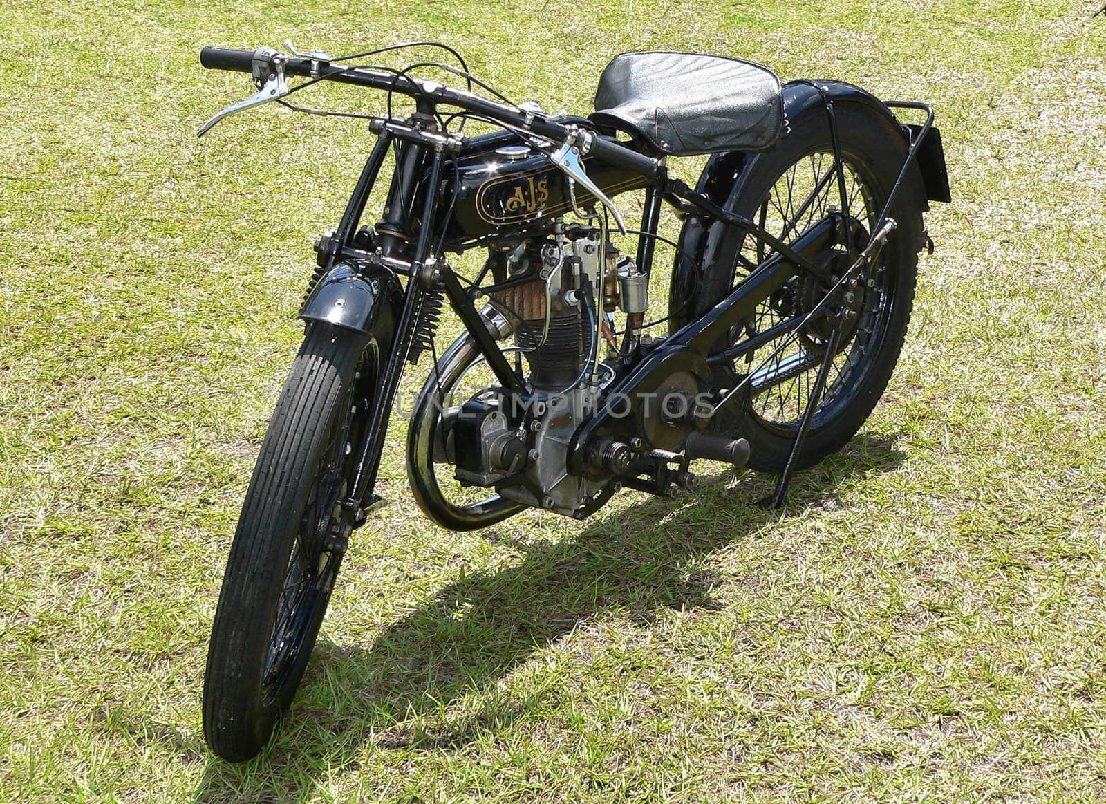 Vintage motorcycle parked on grassy lawn