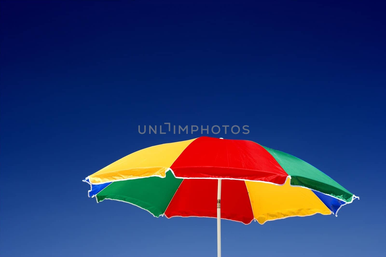  beach umbrella and deep blue sky