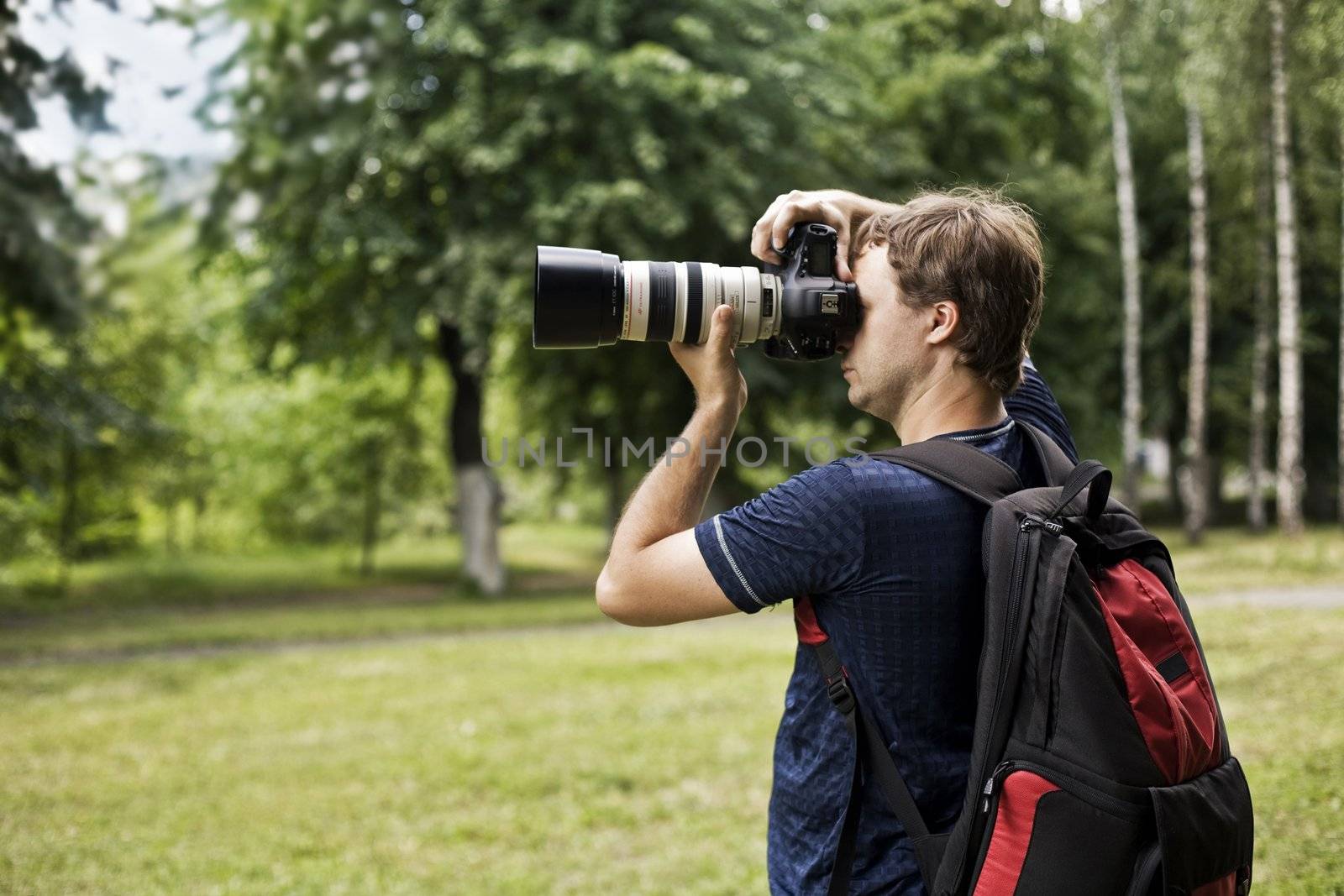 professional men photographer work on the nature
