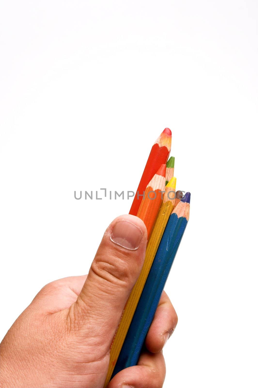 Hand holding color pensils over white
