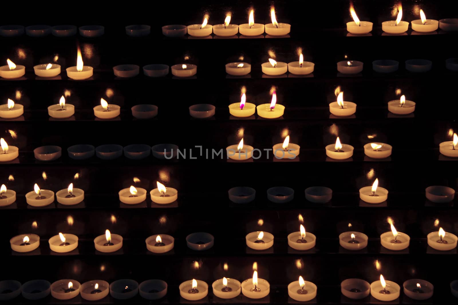 candles alight within a church