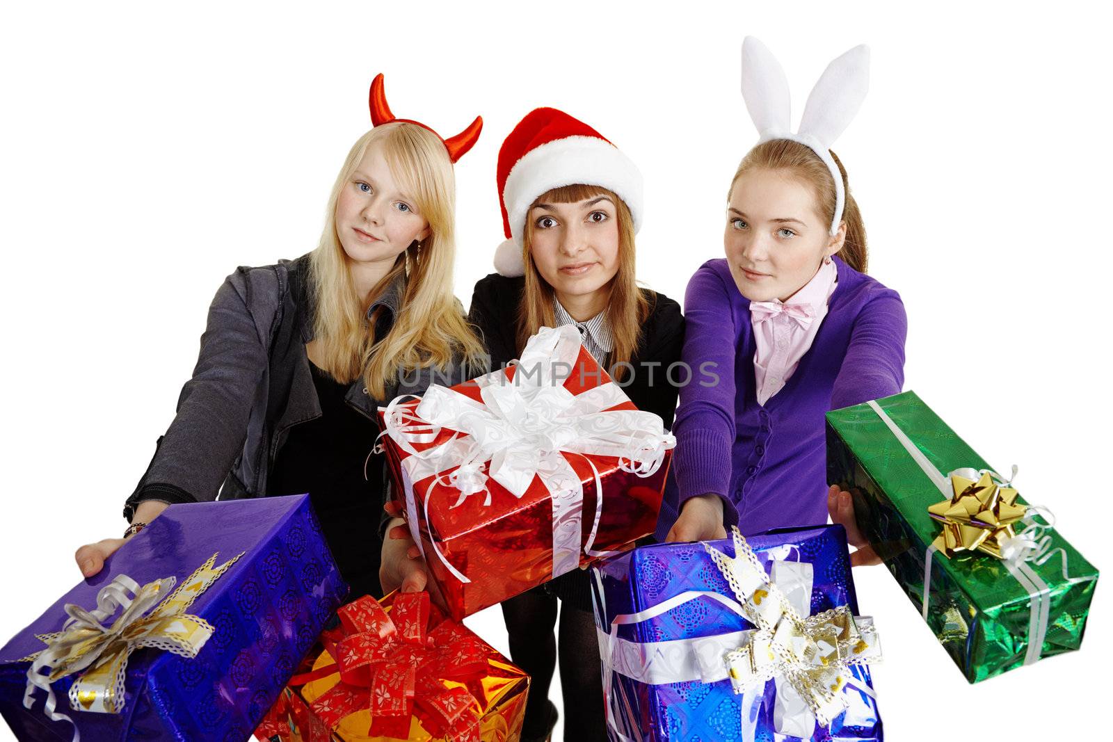 Three girls hand over New Year's gifts isolated on a white background