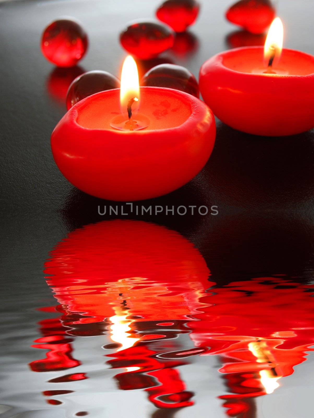 spa candle and water reflection showing zen concept