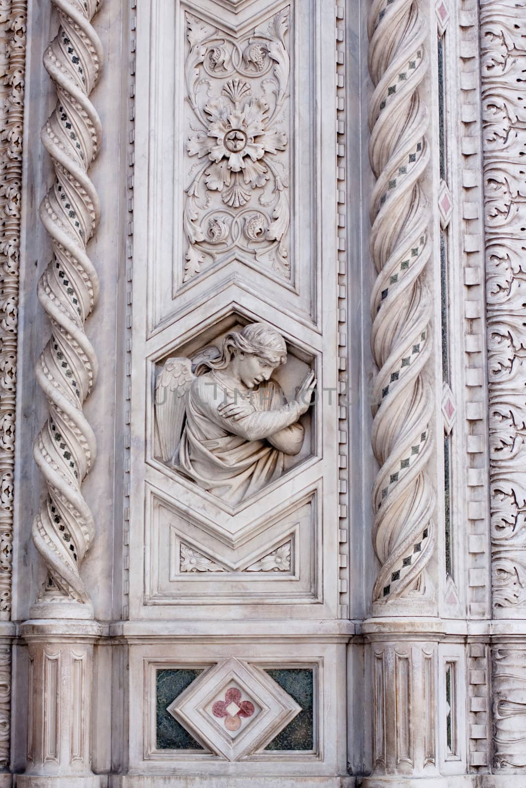 A stone angel on a wall
