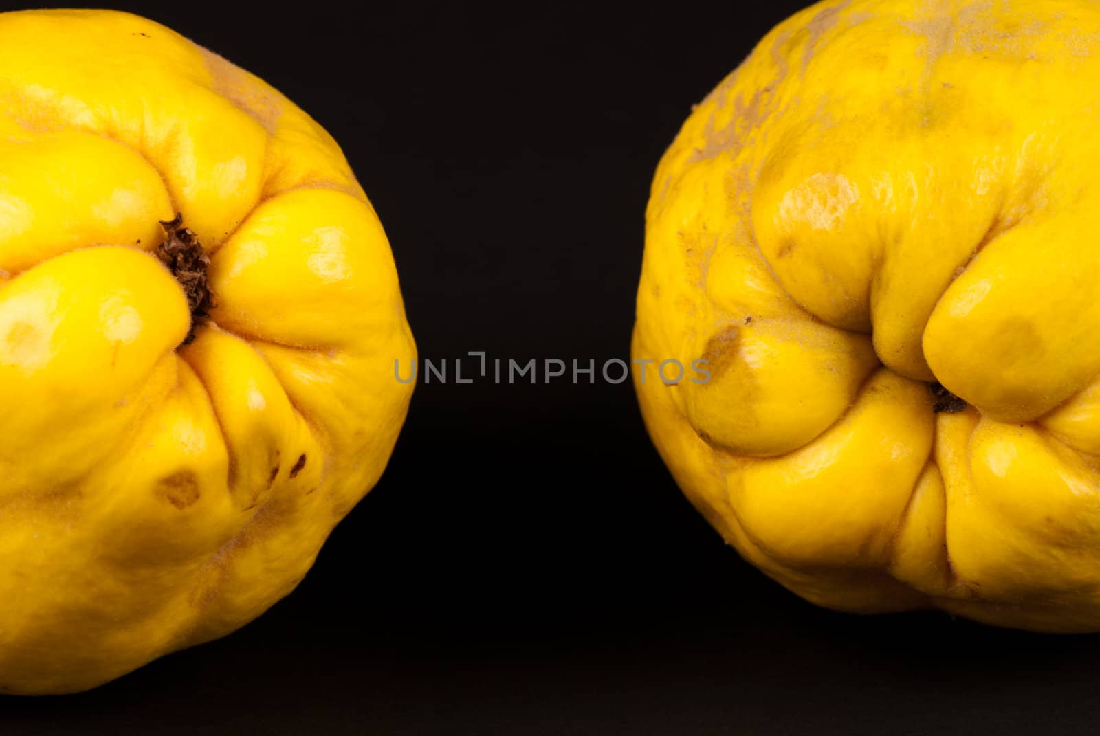 Fresh quince fruit isolated on black background