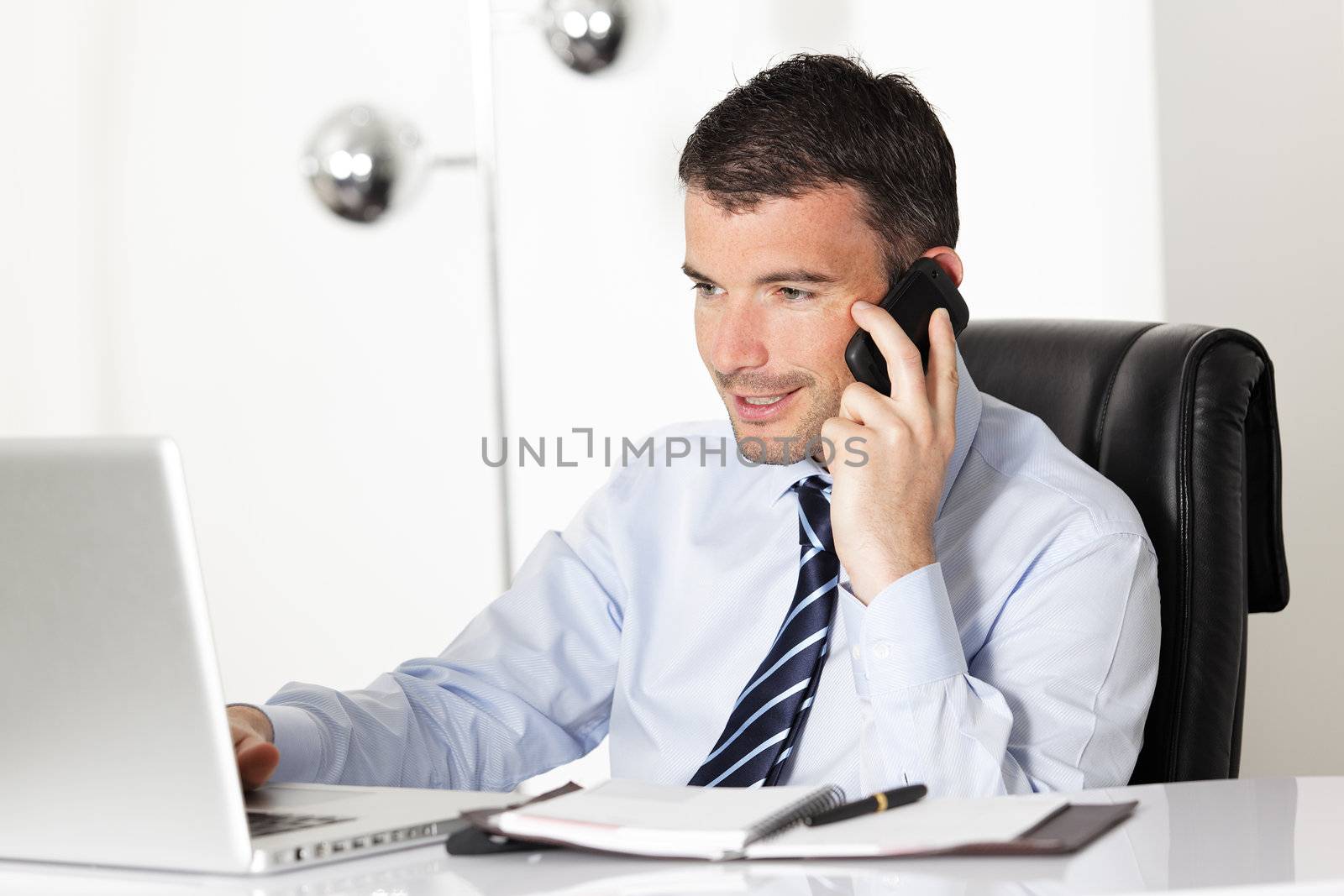 young businessman on the phone in office