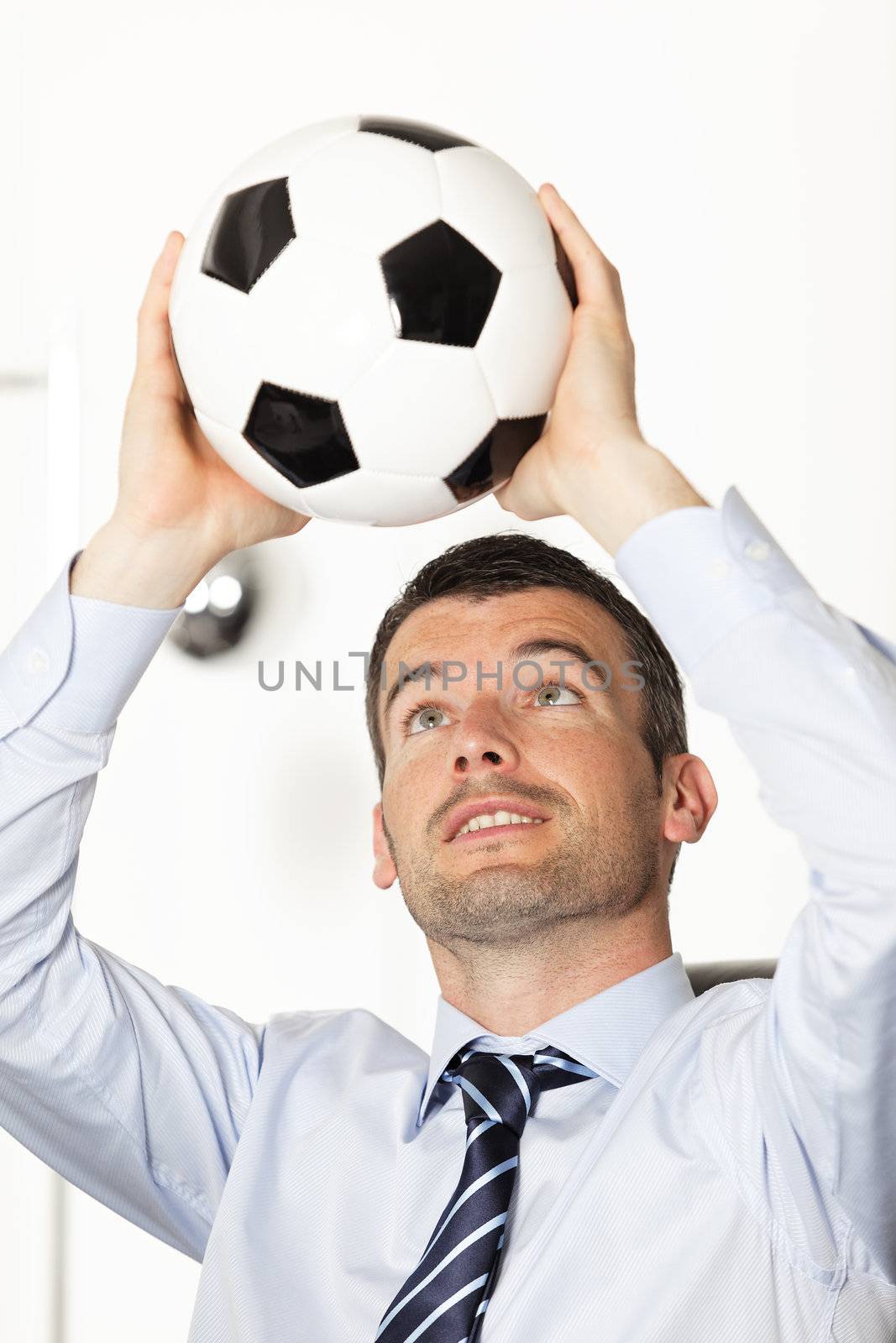 young businessman in office with ball in the hands