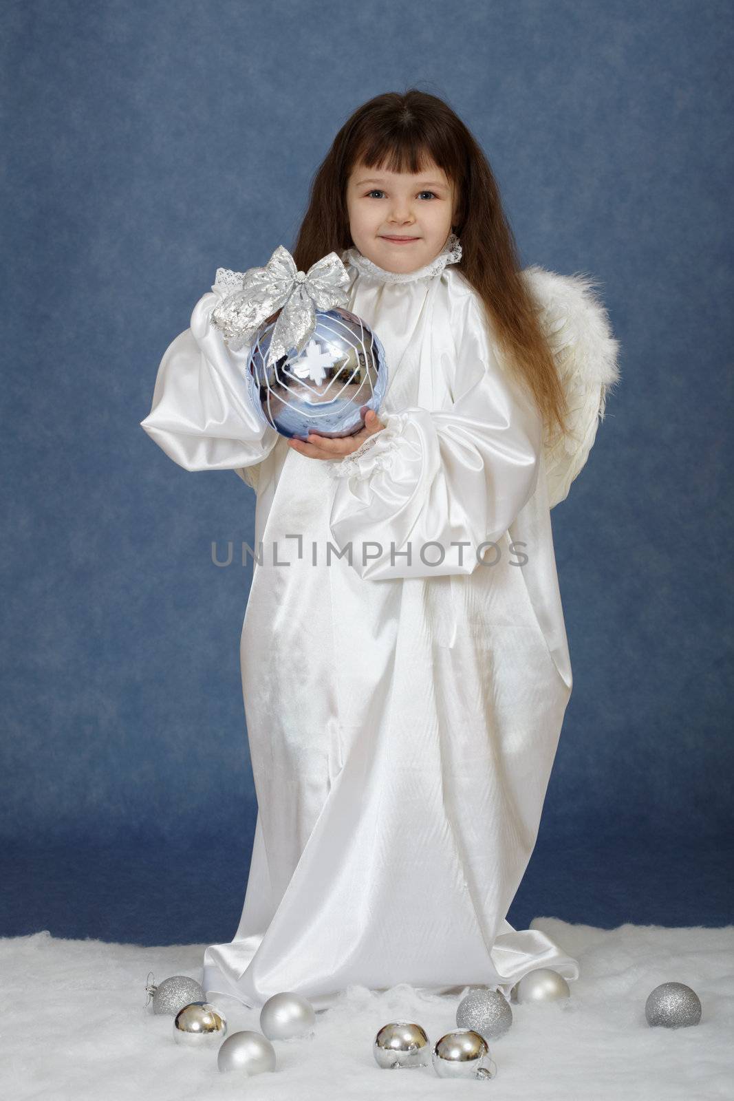 Girl holding a New Year's ball on a blue background
