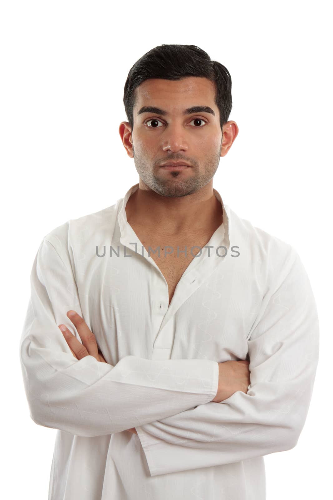 A casual ethnic man with arms crossed and looking ahead.  White background.