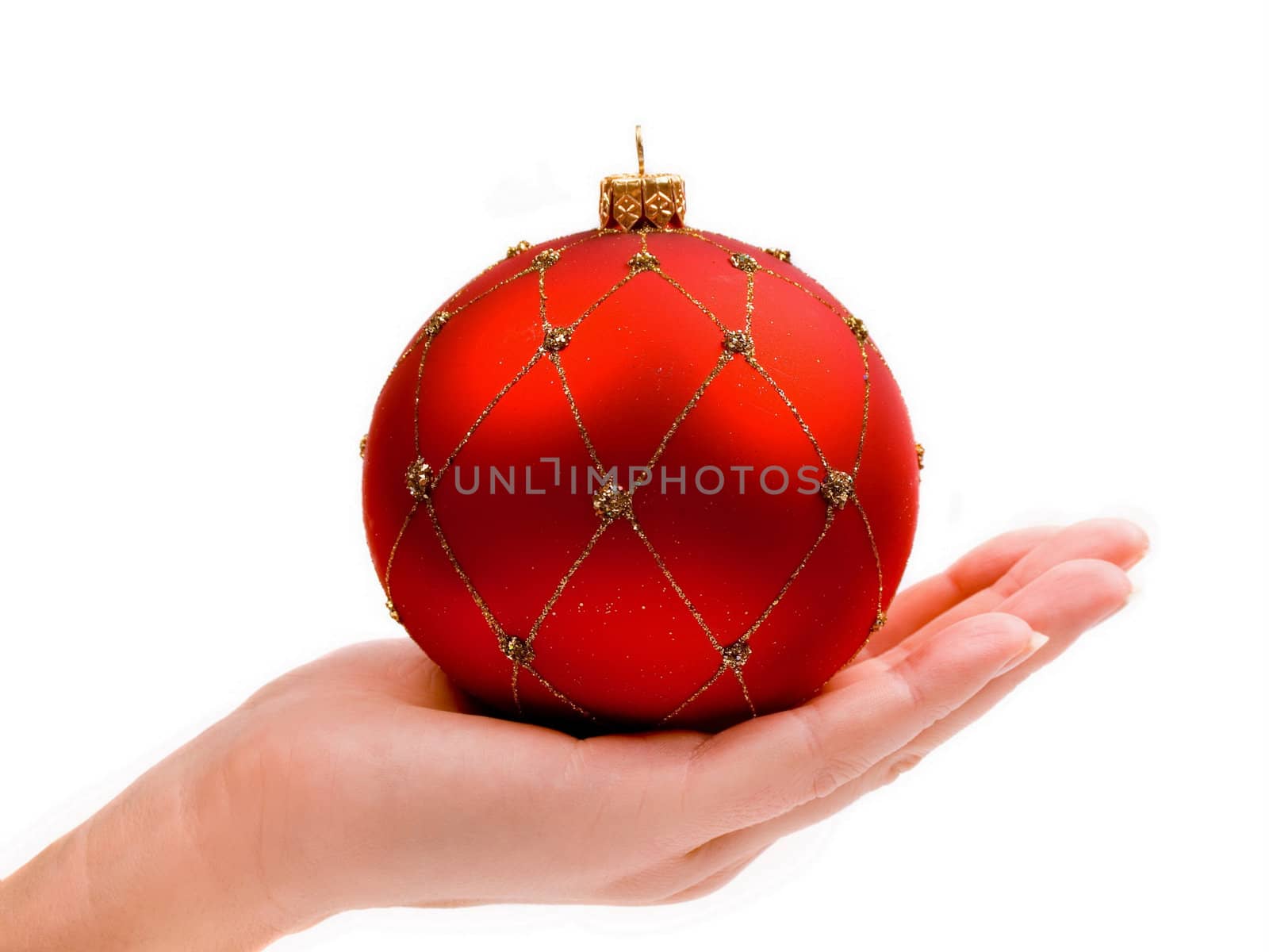 Woman's hand holding a Christmas red ornament