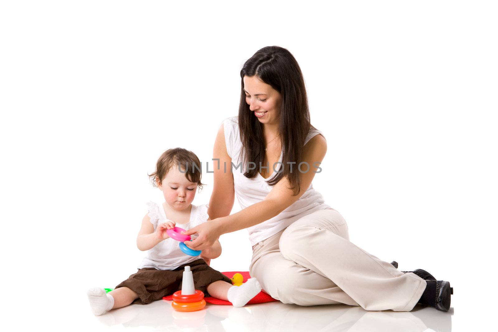 Mother playing with child holding pyramid isolated on white