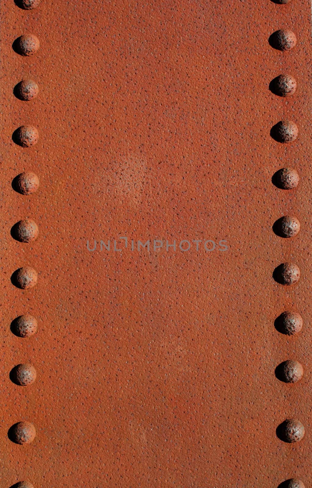 A Rusty metal plate with rivets