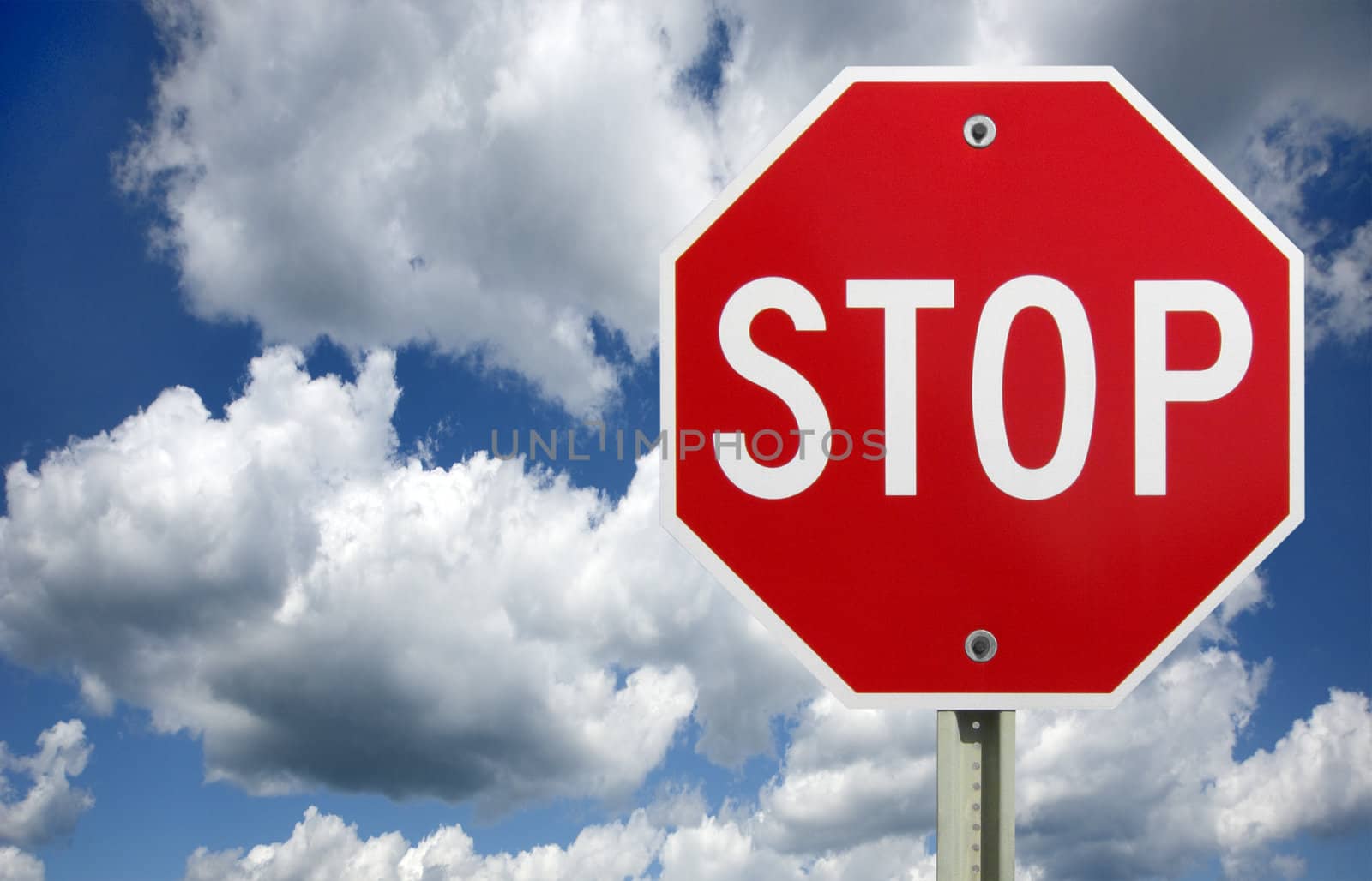 stop sign against blue sky and white clouds, sign isolated with clipping path