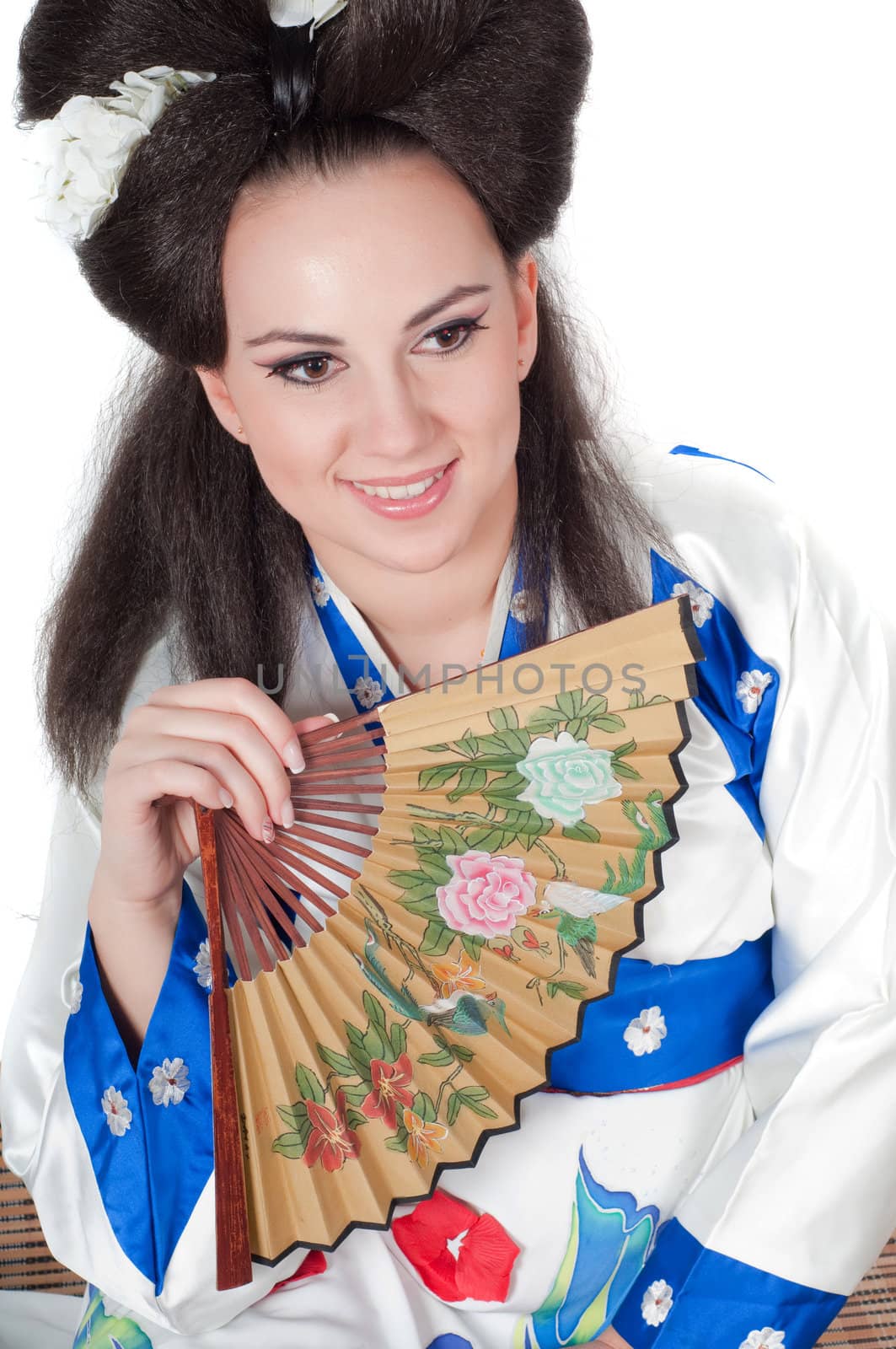 Portrait of the girl of the Asian appearance with a make-up under the geisha on a white background