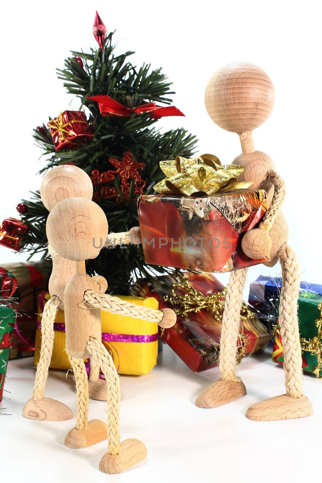 a family of dolls under the Christmas tree