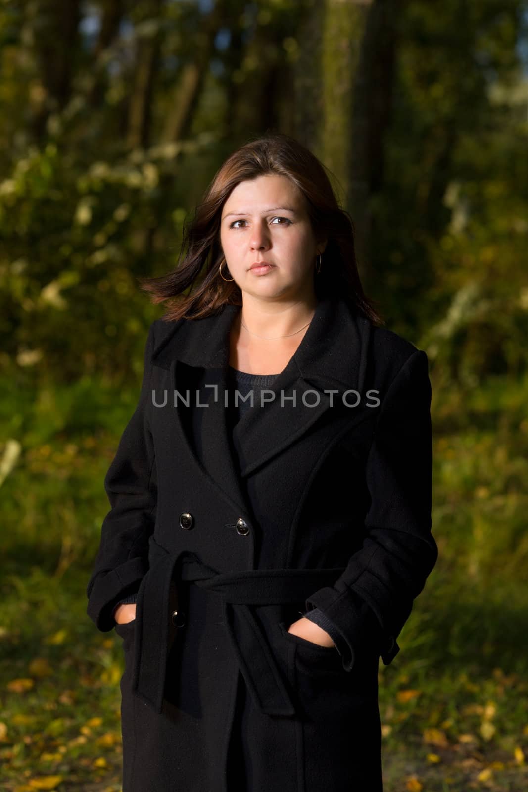 One Woman outdoors wearing black coat autumn park